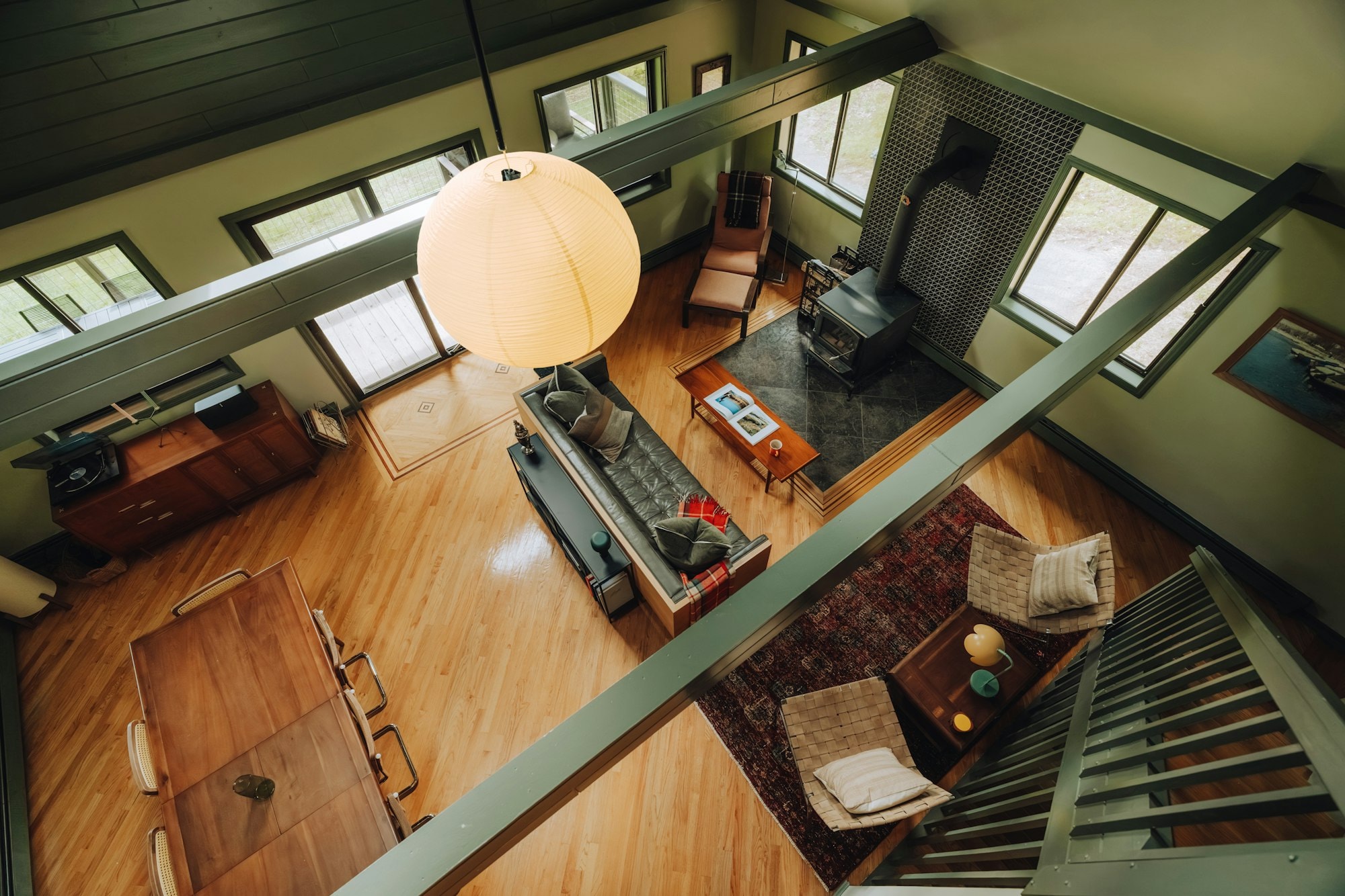 Bright open living space with wood floors and a high ceiling