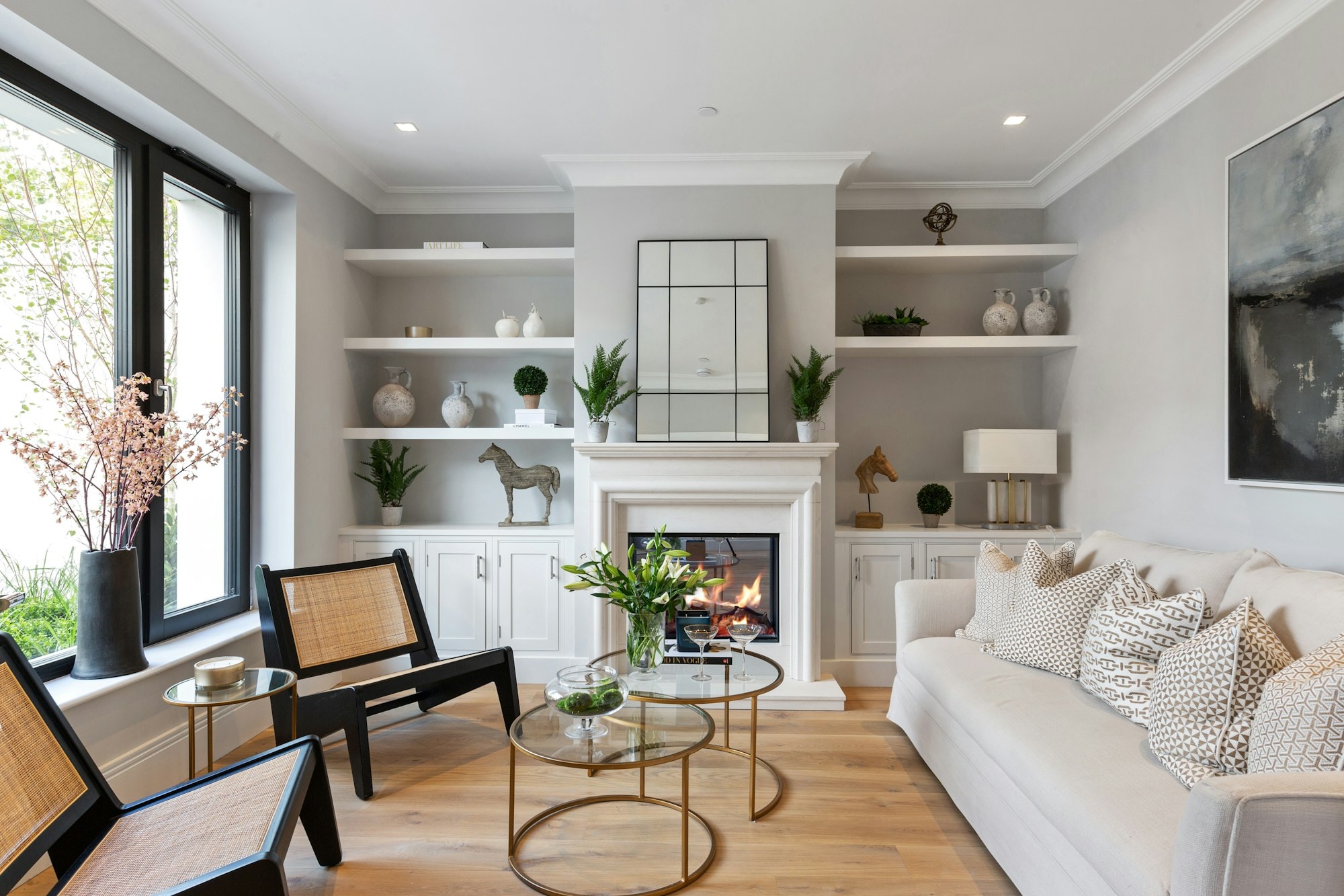 Renovated living room with built-in shelving around a fireplace